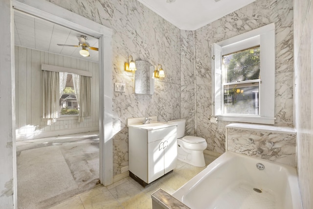 bathroom with vanity, ceiling fan, crown molding, a bath, and toilet