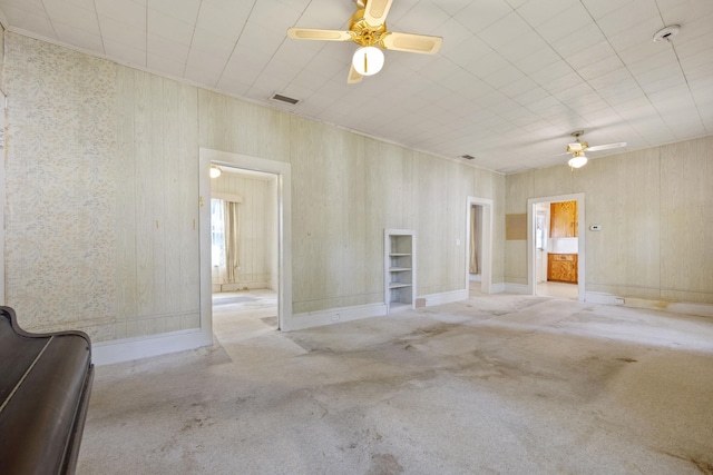 unfurnished room with ceiling fan and light colored carpet