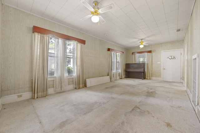 carpeted empty room featuring ceiling fan