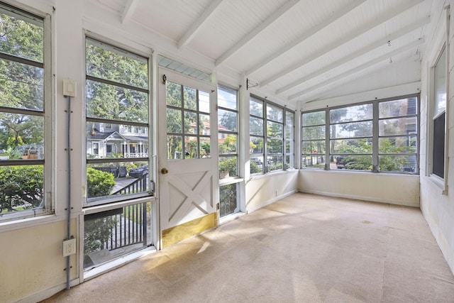 unfurnished sunroom with vaulted ceiling with beams and a healthy amount of sunlight