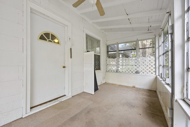 unfurnished sunroom featuring ceiling fan and lofted ceiling with beams