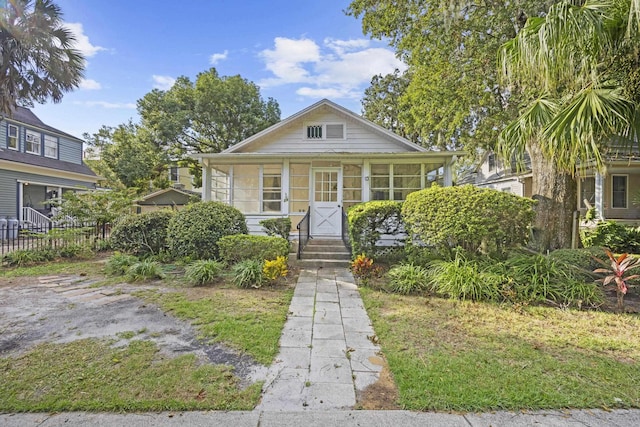 bungalow-style house with a sunroom