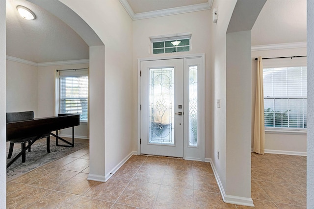 tiled entrance foyer featuring crown molding