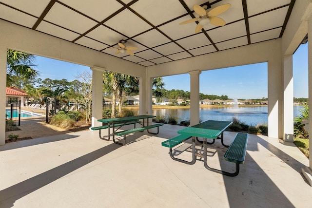 view of patio / terrace featuring a water view and ceiling fan