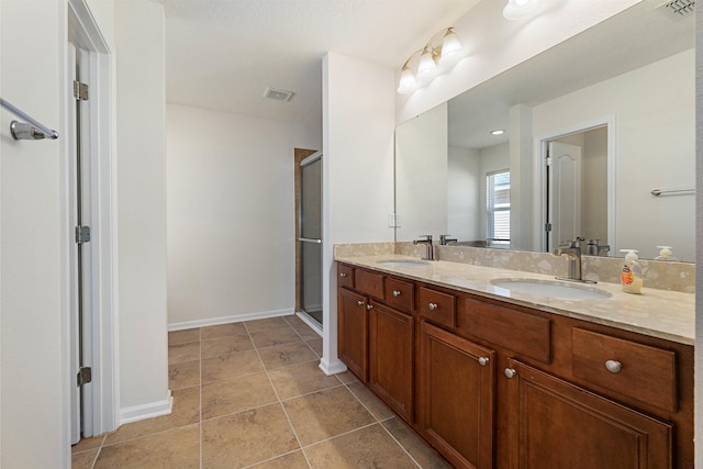 bathroom featuring tile patterned floors, vanity, and an enclosed shower