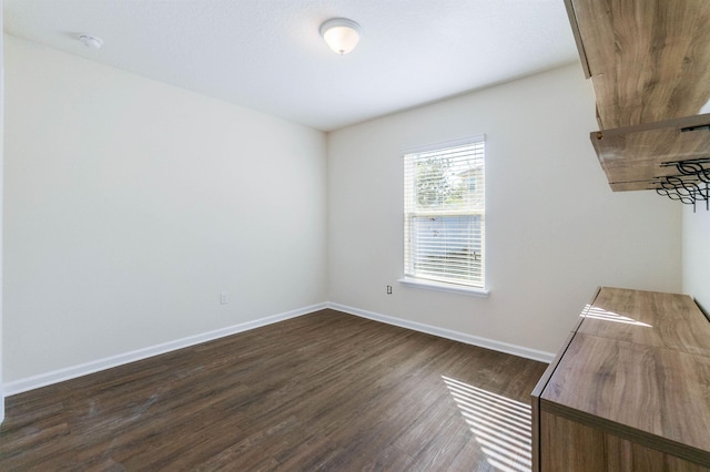 empty room with dark hardwood / wood-style floors