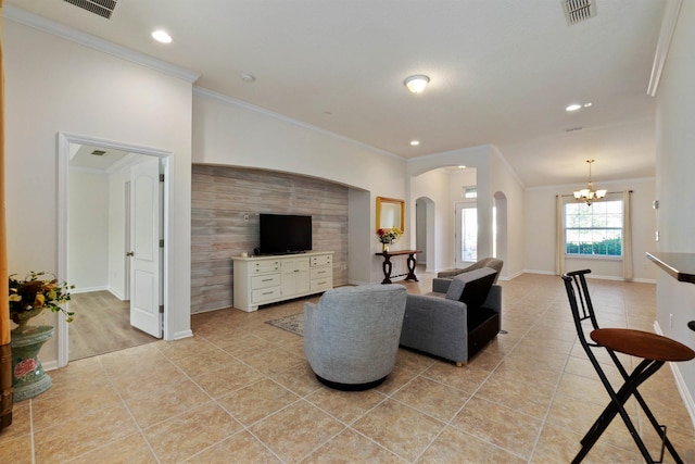 tiled living room with ornamental molding and a notable chandelier