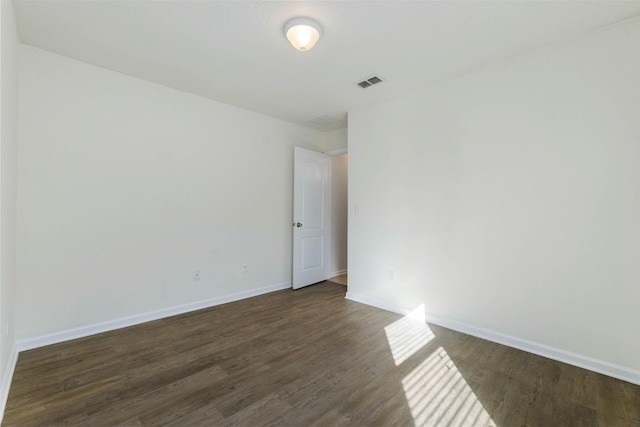 spare room featuring dark hardwood / wood-style floors