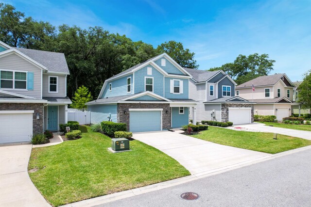 view of front of house with a front yard and a garage