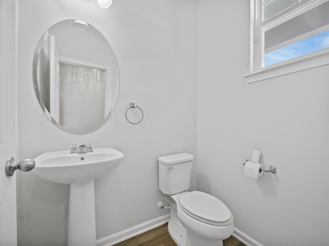 bathroom featuring hardwood / wood-style floors, toilet, and sink