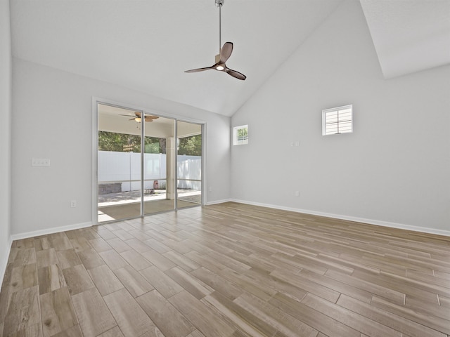 unfurnished room with ceiling fan, light wood-type flooring, and high vaulted ceiling