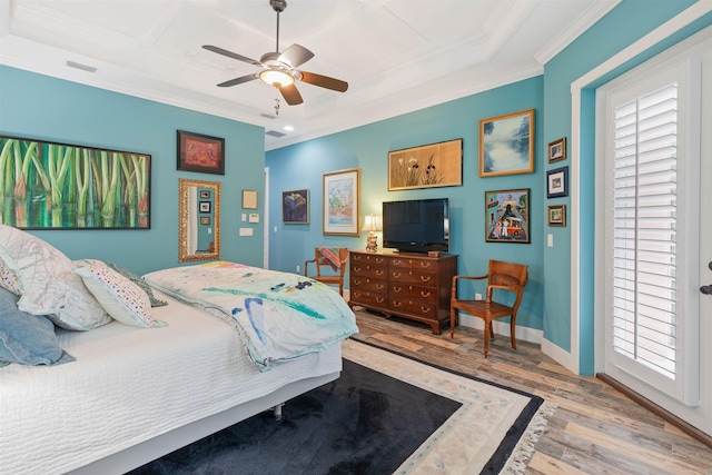 bedroom with light wood-type flooring, ceiling fan, and ornamental molding