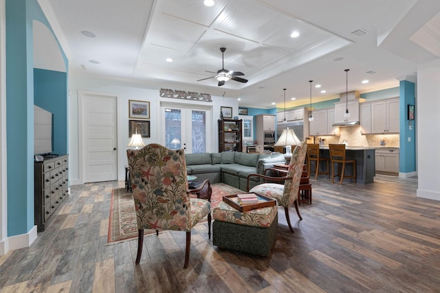 living room with ceiling fan, dark hardwood / wood-style floors, and ornamental molding