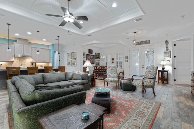 living room with hardwood / wood-style floors, french doors, crown molding, and ceiling fan