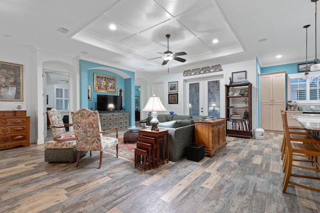 living room with french doors, hardwood / wood-style flooring, ceiling fan, and ornamental molding