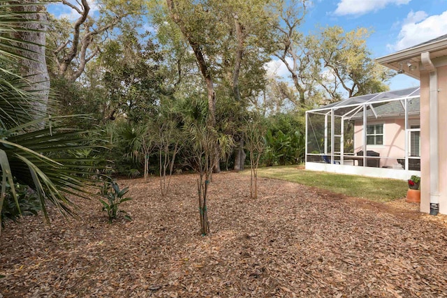 view of yard featuring glass enclosure