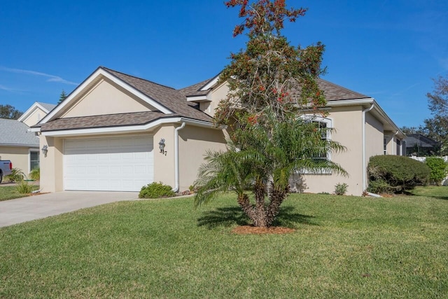 view of front of home featuring a garage and a front lawn