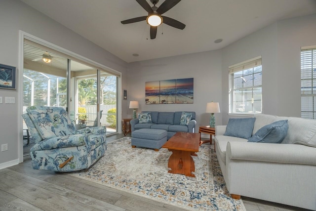 living room with ceiling fan and light hardwood / wood-style floors