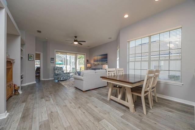 dining area featuring light wood-type flooring and ceiling fan