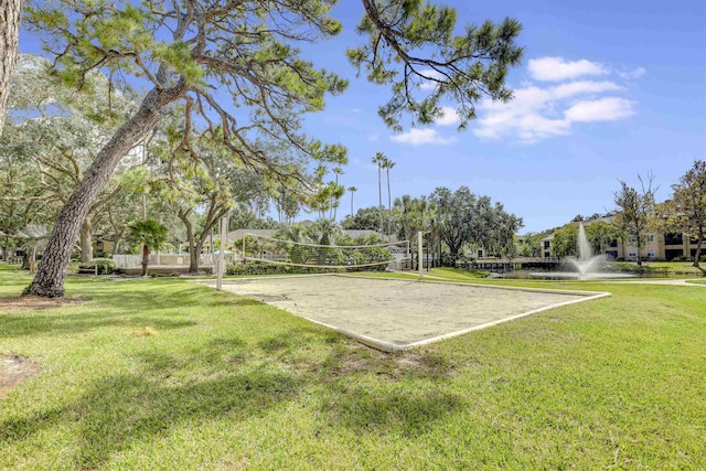 view of property's community with volleyball court and a lawn