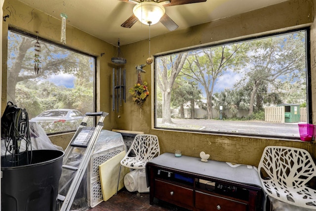 sunroom / solarium featuring ceiling fan