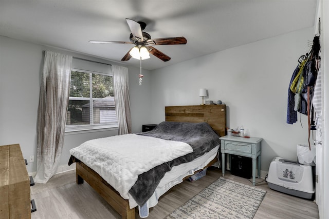 bedroom with ceiling fan and light hardwood / wood-style floors