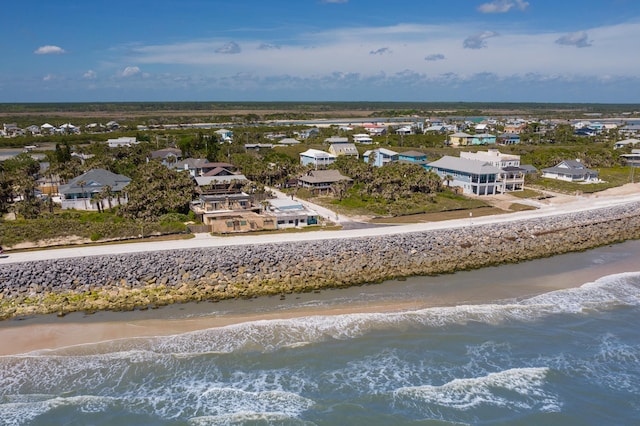 drone / aerial view featuring a residential view, a view of the beach, and a water view