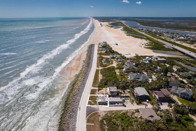 bird's eye view featuring a view of the beach and a water view