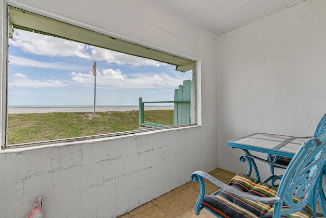 sunroom / solarium featuring plenty of natural light and a water view