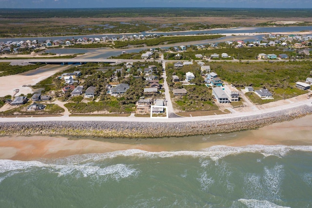 bird's eye view featuring a view of the beach, a water view, and a residential view