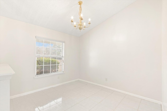 tiled spare room featuring vaulted ceiling and an inviting chandelier