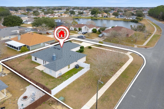 birds eye view of property with a water view