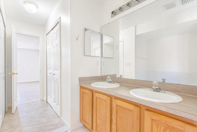 bathroom with vanity and a textured ceiling