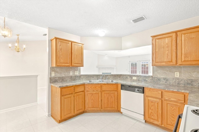 kitchen featuring dishwasher, stove, sink, and a textured ceiling