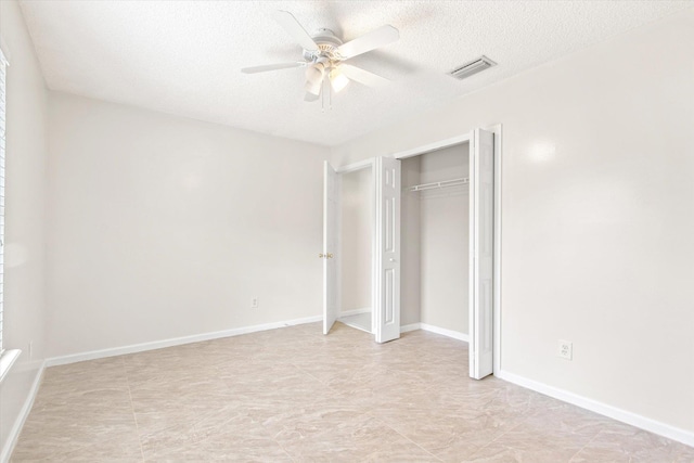 unfurnished bedroom with ceiling fan, a closet, and a textured ceiling