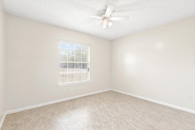 unfurnished room with a textured ceiling and ceiling fan