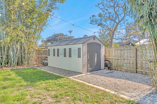 view of shed with a fenced backyard