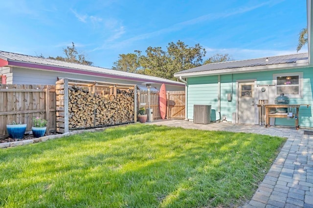 exterior space featuring a gate, fence, and central AC