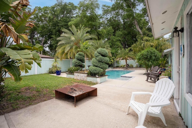 view of swimming pool featuring a patio, a yard, a fenced backyard, and a fenced in pool