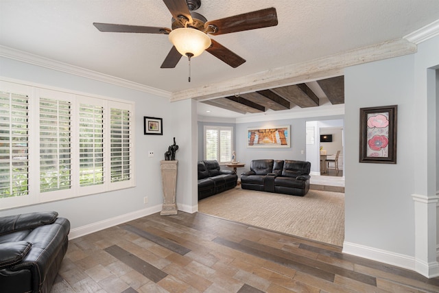 living area featuring ornamental molding, beam ceiling, baseboards, and hardwood / wood-style floors