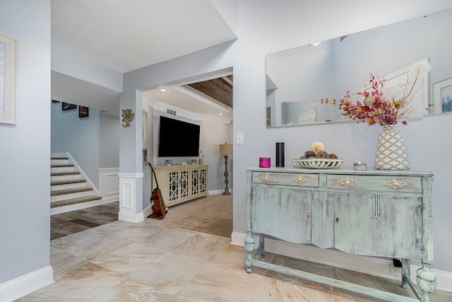 interior space featuring a wainscoted wall, stairway, a decorative wall, and recessed lighting