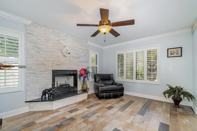 living area featuring a healthy amount of sunlight and crown molding