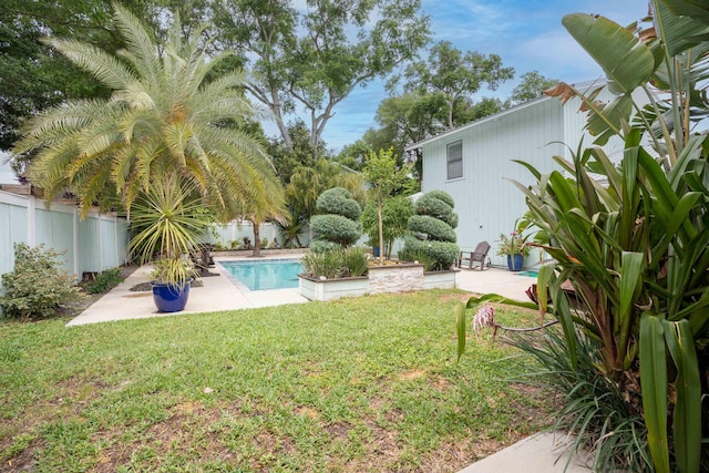 view of yard featuring a patio, a fenced backyard, and an outdoor pool