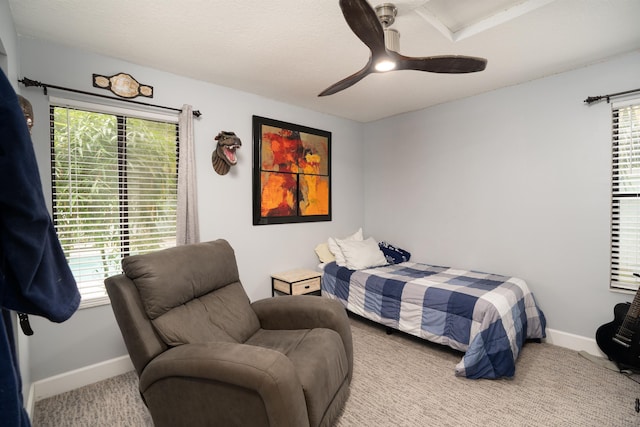 bedroom featuring carpet floors, ceiling fan, baseboards, and a textured ceiling