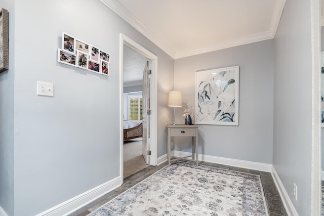 hall featuring ornamental molding, wood finished floors, and baseboards