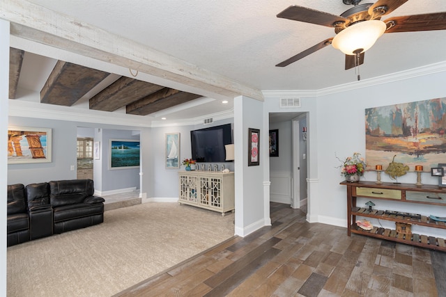 living area featuring visible vents, crown molding, baseboards, and wood finished floors