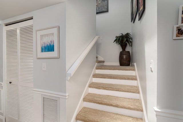 stairs with visible vents and baseboards