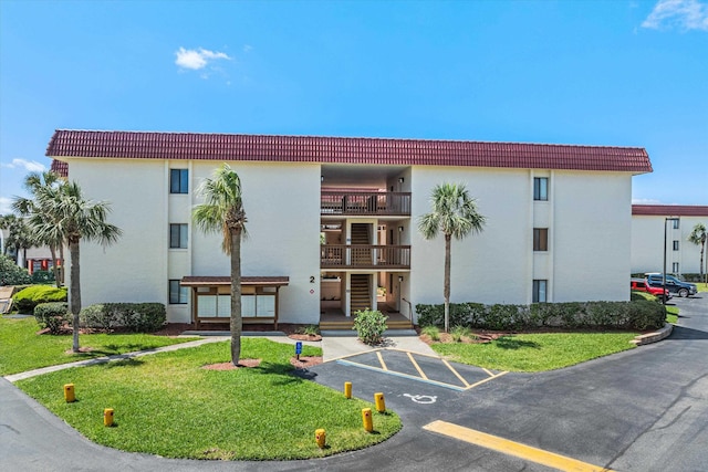view of building exterior with uncovered parking