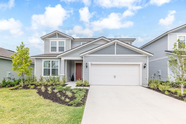 view of front of home featuring concrete driveway, an attached garage, and a front yard