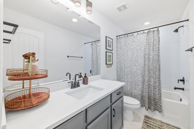 bathroom featuring toilet, vanity, shower / bath combination with curtain, and recessed lighting